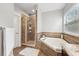 Bathroom with a soaking tub, tiled shower, and granite countertops at 5949 Parkset Dr, Lithia, FL 33547