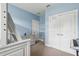 Light blue bedroom with carpet, including a lofted bed, dresser, and storage closet at 5949 Parkset Dr, Lithia, FL 33547