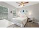 Cozy bedroom with carpet, a ceiling fan, natural light, and a large comfortable bed at 5949 Parkset Dr, Lithia, FL 33547