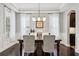Elegant dining room featuring a coffered ceiling, hardwood floors, and a stylish chandelier at 5949 Parkset Dr, Lithia, FL 33547