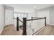 Upstairs hallway featuring carpet flooring, white trim and doors, and a view overlooking the home's staircase at 5949 Parkset Dr, Lithia, FL 33547