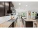 The kitchen features stainless steel appliances, granite countertops, and a view into the dining area at 5949 Parkset Dr, Lithia, FL 33547
