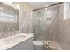 Bathroom featuring a modern glass shower, marble countertops, and updated fixtures at 624 Orange St, Palm Harbor, FL 34683