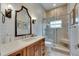 Bathroom with a glass-enclosed shower, stylish vanity, modern fixtures, and decorative tile accents at 6301 Marbella Blvd, Apollo Beach, FL 33572