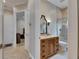 Modern bathroom features include a wood vanity, updated fixtures, and a glass-enclosed shower for a spa-like experience at 6301 Marbella Blvd, Apollo Beach, FL 33572