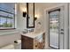 Bathroom featuring a wood vanity, stylish fixtures, and subway tile, with an open window for natural light at 6301 Marbella Blvd, Apollo Beach, FL 33572