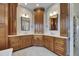 Bright bathroom featuring and sinks, wood cabinets, and white countertops at 6301 Marbella Blvd, Apollo Beach, FL 33572