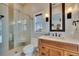 Elegant bathroom with a glass shower, a stylish vanity with sconces, and classic subway tile at 6301 Marbella Blvd, Apollo Beach, FL 33572