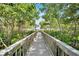 Charming boardwalk surrounded by lush trees and greenery, creating a peaceful pathway at 6301 Marbella Blvd, Apollo Beach, FL 33572