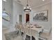 Elegant dining room with high ceilings, stylish lighting, and a sophisticated tablesetting for formal gatherings at 6301 Marbella Blvd, Apollo Beach, FL 33572