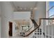 Bright foyer featuring a staircase, dining area, and an open view of the second-floor landing at 6301 Marbella Blvd, Apollo Beach, FL 33572
