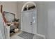 Inviting foyer with a beautiful door, staircase, and an elegant decor at 6301 Marbella Blvd, Apollo Beach, FL 33572
