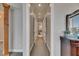 Bright hallway with recessed lighting leading to bathroom and featuring a dresser and view of the living space at 6301 Marbella Blvd, Apollo Beach, FL 33572