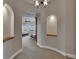 Hallway with arched doorways and niche lighting leads to a bedroom at 6301 Marbella Blvd, Apollo Beach, FL 33572
