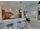 Open-concept kitchen featuring a breakfast bar, pendant lighting, white countertops and stainless steel appliances at 6301 Marbella Blvd, Apollo Beach, FL 33572