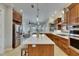 A modern kitchen with stainless steel appliances, a large island, and seamless flow into the living area at 6301 Marbella Blvd, Apollo Beach, FL 33572