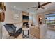Comfortable living room with stone fireplace, tv, ceiling fan, and comfortable seating creating a relaxing atmosphere at 6301 Marbella Blvd, Apollo Beach, FL 33572