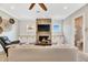 Cozy living room with a stone fireplace, built-in cabinets, and neutral-toned furniture creating a relaxing atmosphere at 6301 Marbella Blvd, Apollo Beach, FL 33572