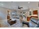 Relaxing living room with outdoor access, a ceiling fan, a connected dining area, and modern furnishings at 6301 Marbella Blvd, Apollo Beach, FL 33572
