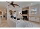 Spacious living room with a stone fireplace, TV, ceiling fan, neutral decor, and an open layout for entertaining at 6301 Marbella Blvd, Apollo Beach, FL 33572