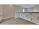 Loft space featuring built-in bookshelves, neutral paint, and plush carpeting, perfect for relaxing at 6301 Marbella Blvd, Apollo Beach, FL 33572