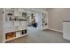 Loft area featuring built-in bookshelves and an open doorway to a sitting room with comfortable furniture at 6301 Marbella Blvd, Apollo Beach, FL 33572