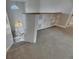Loft area with built-in bookshelves, stairs leading down, and natural light from a large window at 6301 Marbella Blvd, Apollo Beach, FL 33572