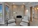 Sitting area in the main bedroom with stone fireplace and plush seating at 6301 Marbella Blvd, Apollo Beach, FL 33572