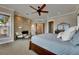 Bedroom featuring stone fireplace, windows, and comfortable furniture at 6301 Marbella Blvd, Apollo Beach, FL 33572