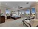 Bright bedroom featuring large windows and sitting area with chairs at 6301 Marbella Blvd, Apollo Beach, FL 33572
