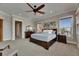 Comfortable bedroom with fan, and ample natural light from several windows at 6301 Marbella Blvd, Apollo Beach, FL 33572