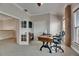 Well-lit office features a modern desk, comfortable seating, and built-in bookshelves in an adjacent room at 6301 Marbella Blvd, Apollo Beach, FL 33572