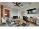 Office boasts comfortable seating, a modern desk, and opens to a cozy seating area with a television at 6301 Marbella Blvd, Apollo Beach, FL 33572