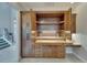 A home office nook in a luxurious house features built-in cabinetry, lighting, and a sleek, functional design at 6301 Marbella Blvd, Apollo Beach, FL 33572