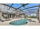 Beautiful in-ground pool is perfect for relaxing and entertaining in this home's outdoor living area at 6301 Marbella Blvd, Apollo Beach, FL 33572