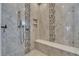 Luxurious walk-in shower with bench and rain shower head, detailed with stylish tile at 6301 Marbella Blvd, Apollo Beach, FL 33572