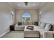 Sitting room featuring arched windows, a plush sectional sofa, and recessed lighting for a comfortable setting at 6301 Marbella Blvd, Apollo Beach, FL 33572