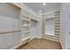 Spacious walk-in closet with ample built-in shelving and hanging rods, perfect for organization at 6301 Marbella Blvd, Apollo Beach, FL 33572