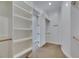 Large walk-in closet with built-in shelves and hanging rods with a doorway looking into the hallway at 6301 Marbella Blvd, Apollo Beach, FL 33572