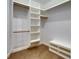 Well-organized walk-in closet with built-in shelving, hanging rods, and a convenient bench at 6301 Marbella Blvd, Apollo Beach, FL 33572