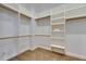 Bright walk-in closet featuring ample built-in shelving and hanging rods at 6301 Marbella Blvd, Apollo Beach, FL 33572