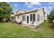 Backyard with a covered patio, lush grass, and privacy landscaping at 6529 Thicket Trl, New Port Richey, FL 34653