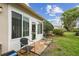 Screened in porch overlooking green lawn, blue skies, and mature shade trees in a backyard setting at 6529 Thicket Trl, New Port Richey, FL 34653
