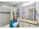 Well-lit bathroom featuring a tub, shower, granite countertop, and decorative turtle-themed shower curtain at 6529 Thicket Trl, New Port Richey, FL 34653