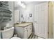 Modern bathroom with tiled floors, a granite countertop, and a stack of neatly arranged towels at 6529 Thicket Trl, New Port Richey, FL 34653