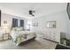 Comfortable bedroom with carpeted floors, a ceiling fan and ample natural light at 6529 Thicket Trl, New Port Richey, FL 34653