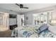 Spacious bedroom with carpeted floors, a ceiling fan and access to the enclosed lanai at 6529 Thicket Trl, New Port Richey, FL 34653