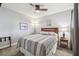 Cozy bedroom with a wood-frame bed, ceiling fan, side table, and calming decor at 6529 Thicket Trl, New Port Richey, FL 34653