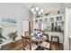 Cozy dining area with wood floors and a round table set for dinner adjacent to the kitchen bar at 6529 Thicket Trl, New Port Richey, FL 34653