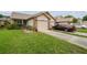 Attractive home featuring well-maintained landscaping and a two-car garage at 6529 Thicket Trl, New Port Richey, FL 34653